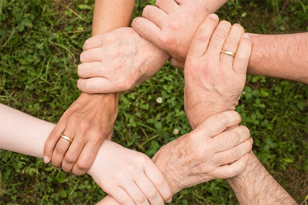 Group of hands supporting each other